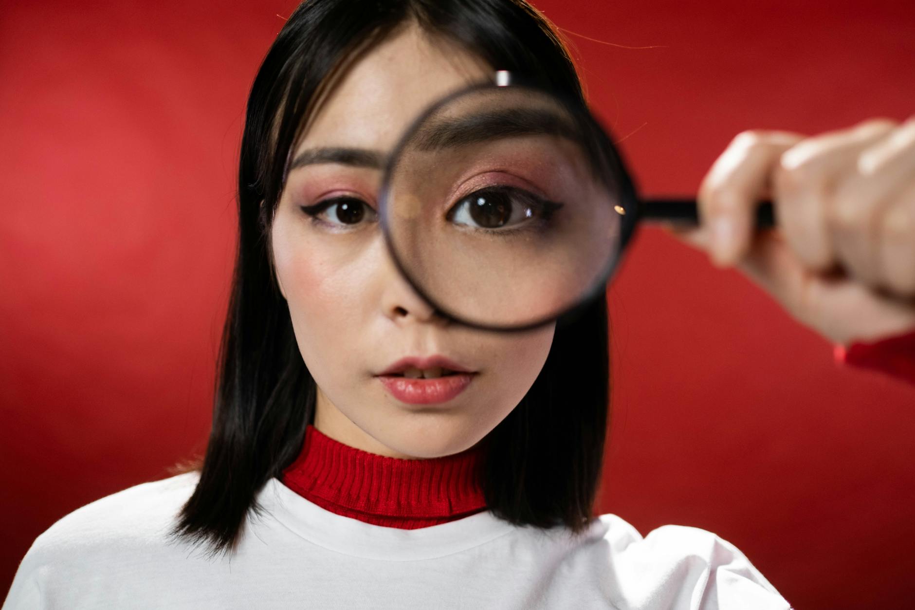 a woman looking through a magnifying glass